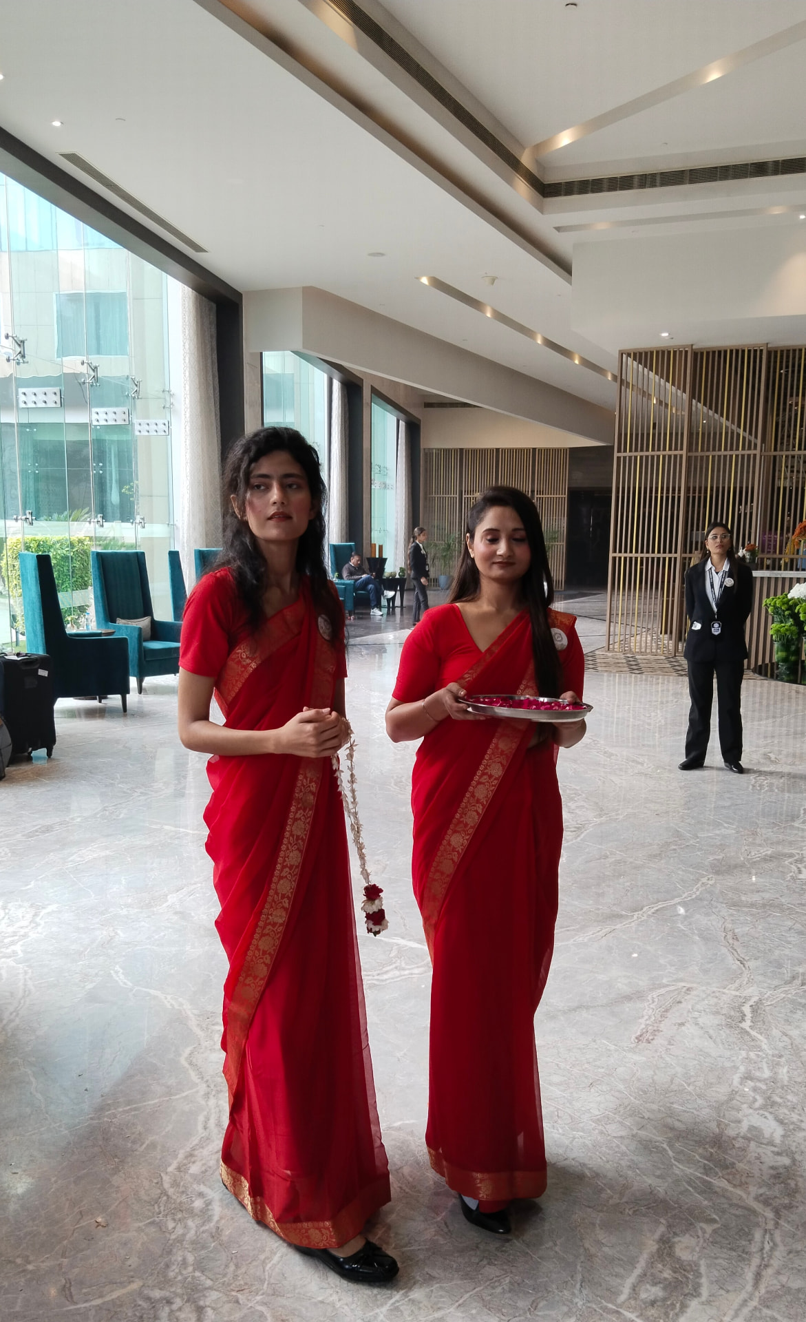 Harmony hostesses welcoming guests with rose petals in a hotel lobby