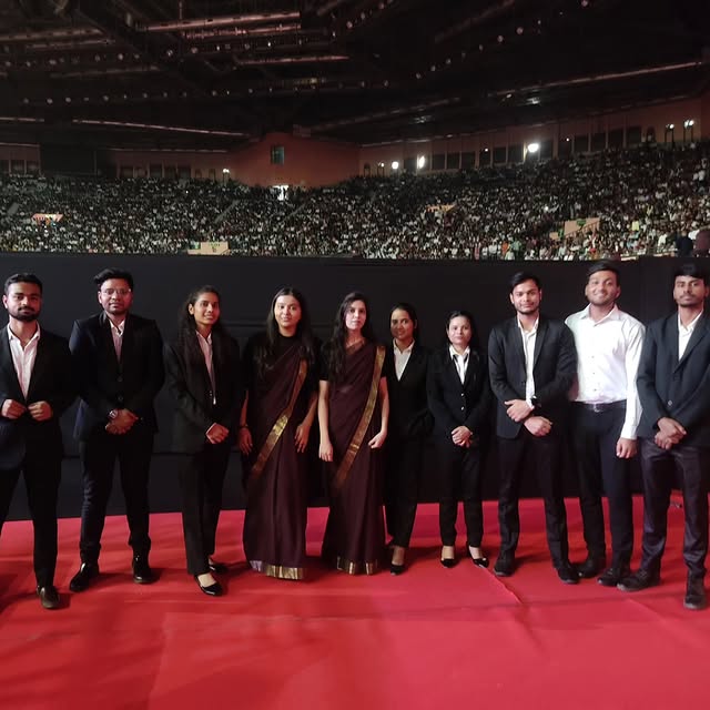 Harmony crew on the red carpet of a stadium-scale corporate event