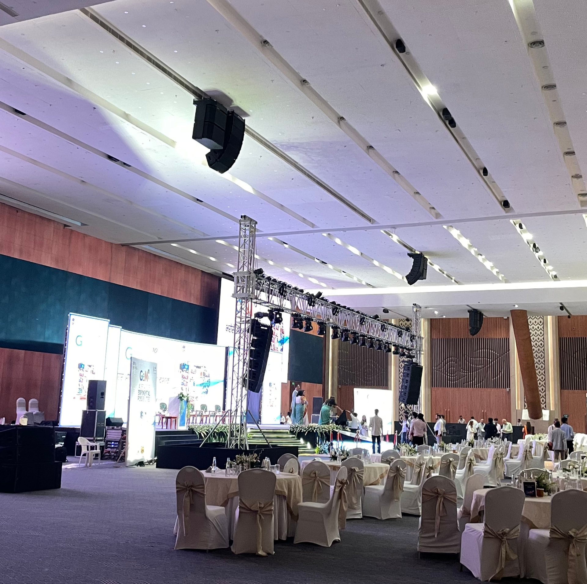 GeM conclave ballroom set up with banquet seating and stage lighting