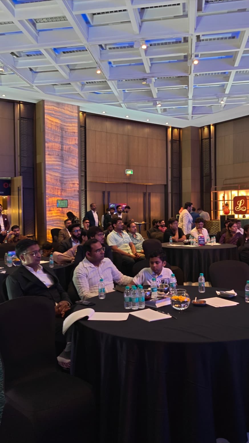 Delegates seated at a corporate summit managed by Harmony