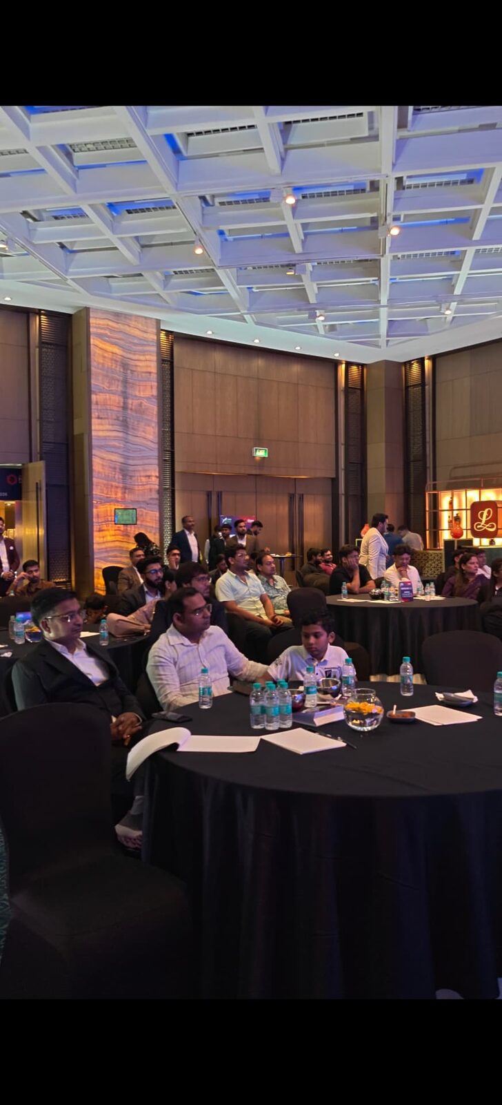 Delegates seated at a corporate conference managed by Harmony