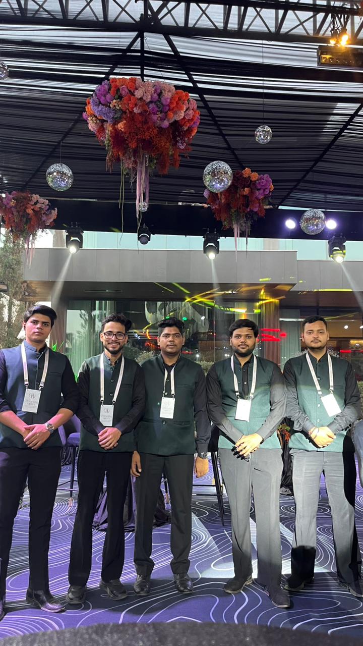 Harmony ushers under floral installations at a gala