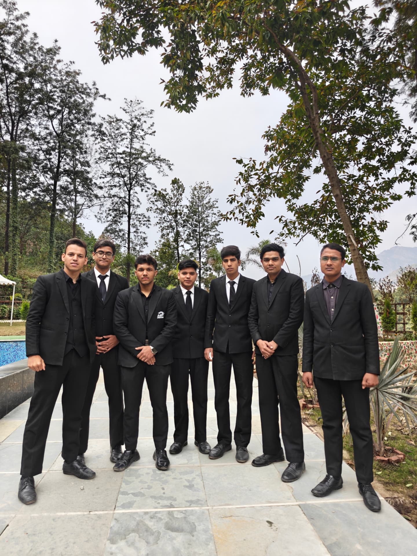 Harmony crew in formal suits at a resort venue